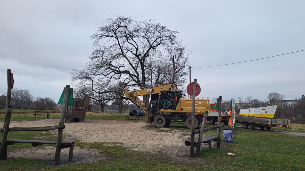 Ein Baufahrzeug steht auf einem Kinderspielplatz.