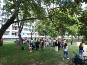 Erwachsene und Kinder beim Abschluss des Wohnhoffests auf der Wiese am Spielplatz Hopfgartenstraße